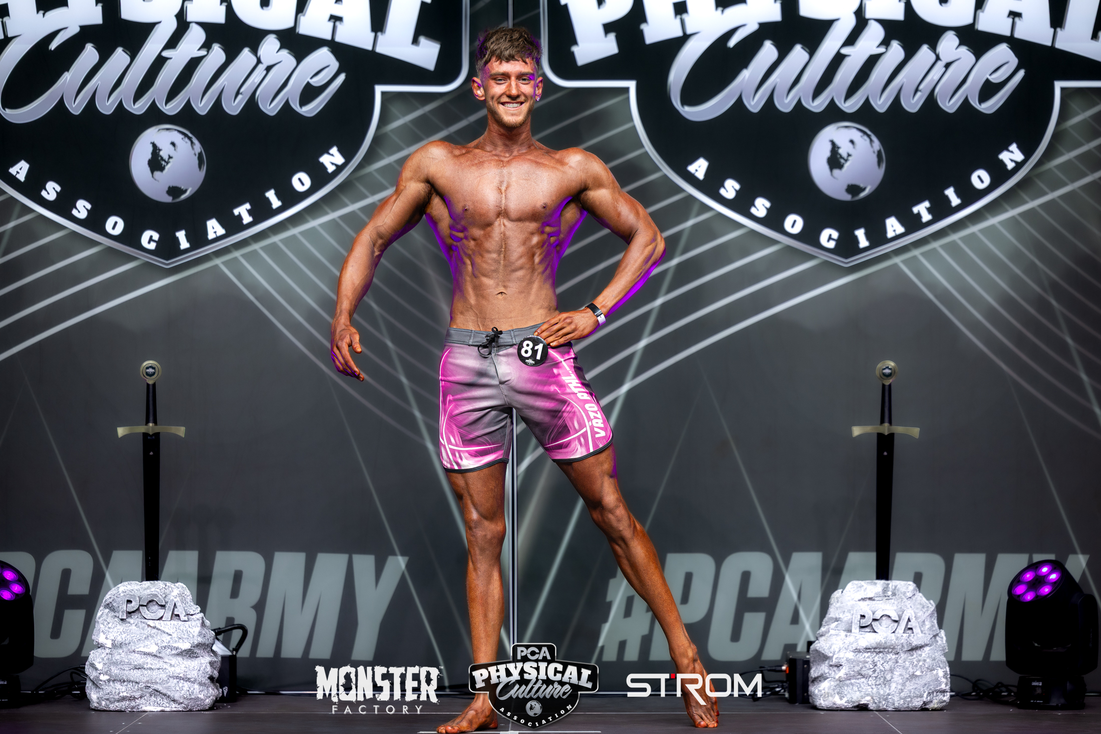 Calum Fraser competing on stage at PCA bodybuilding competition